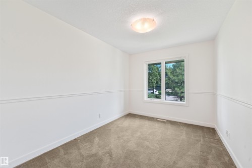 Recessed window with white trim, wall paneling, and ceiling-mounted light fixture - 8212 148 Street Nw, Edmonton, AB 