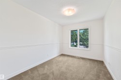 Recessed window with white trim, wall paneling, and ceiling-mounted light fixture - 