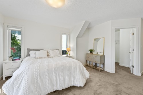 White walls with window trim, neutral carpet flooring, recessed window, and ceiling light fixture - 8212 148 Street Nw, Edmonton, AB 