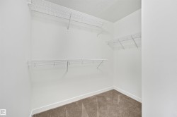 Carpeted closet space with multiple wire shelving units - 