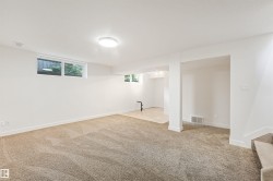 Spacious room featuring neutral carpeting, recessed lighting, and multiple windows - 
