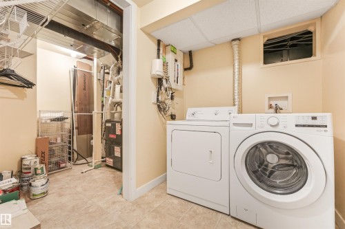 Utility area with laundry appliances and tiled flooring - 8212 148 Street Nw, Edmonton, AB 