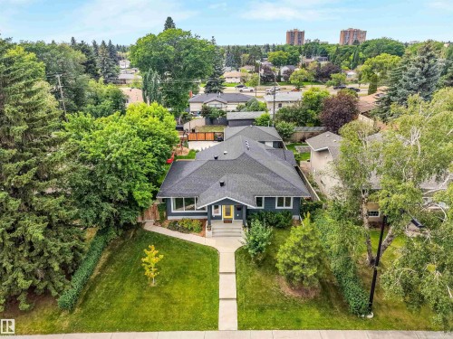 Dark grey exterior with a contrasting yellow front door - 8212 148 Street Nw, Edmonton, AB 