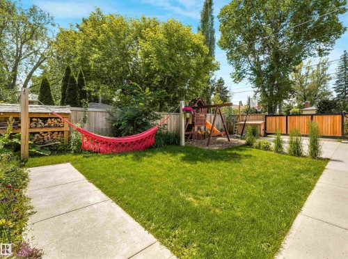 Expansive green lawn with concrete pathways and wood fencing - 8212 148 Street Nw, Edmonton, AB 