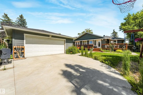 Attached garage with a white sectional door and concrete driveway - 8212 148 Street Nw, Edmonton, AB 