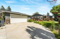 Attached garage with a white sectional door and concrete driveway - 