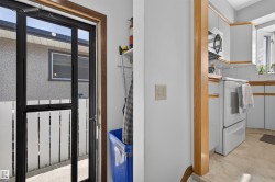 Kitchen featuring white cabinetry, integrated appliances, and a tiled floor - 