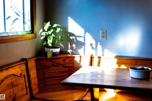 Wood-finish window trim, built-in corner bench seating, wood-finish wainscoting, and a wood-finish tabletop - 11119 137 Avenue Nw, Edmonton, AB 