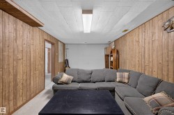Wood-paneled walls and a drop ceiling with recessed lighting - 