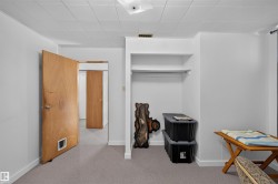 Recessed built-in shelving, wood-finish doors, and soft grey carpeting - 