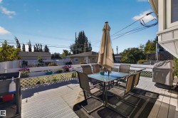 Expansive outdoor deck with a white lattice railing and a built-in planter box - 
