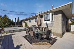 Expansive outdoor decking, stucco exterior, bay window, and lattice railing - 