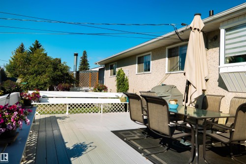 Expansive composite decking featuring a white lattice railing and a stucco exterior - 11119 137 Avenue Nw, Edmonton, AB 