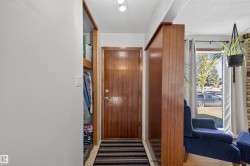 Wood-finish entry door with coordinating wood-finish room divider - 