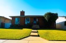 Brick exterior with a prominent chimney, concrete front walkway, and a manicured front lawn - 11119 137 Avenue Nw, Edmonton, AB 