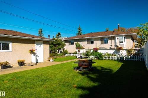 Expansive green lawn with a detached garage and a lower-level deck - 11119 137 Avenue Nw, Edmonton, AB 