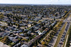 Residential neighborhood with established landscaping, featuring a prominent thoroughfare and a wide expanse of urban development - 