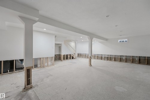 Expansive lower-level space with concrete flooring, recessed lighting, support columns, and partially finished walls - 13420 117 Avenue Nw, Edmonton, AB 