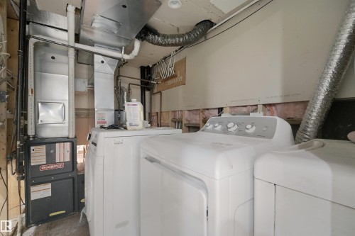 Goodman furnace and hot water heater, with white washer and dryer units - 13420 117 Avenue Nw, Edmonton, AB 