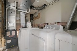 Goodman furnace and hot water heater, with white washer and dryer units - 