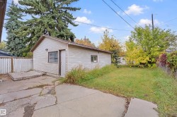 Detached outbuilding with horizontal siding, a single window, and an exterior door - 