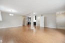 Wood-finish flooring throughout, with a decorative ceiling light fixture - 13420 117 Avenue Nw, Edmonton, AB 