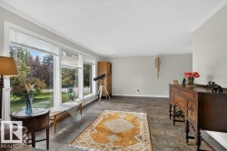 Expansive window wall with white trim, offering abundant natural light - 