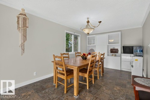 Recessed window with exterior views, built-in white cabinetry with glass-front uppers, and tile flooring - #74 22555 Twp Road 530, Rural Strathcona County, AB 