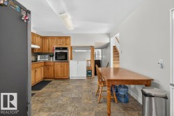 Kitchen featuring wood cabinetry, built-in oven, tile flooring, and recessed lighting - 