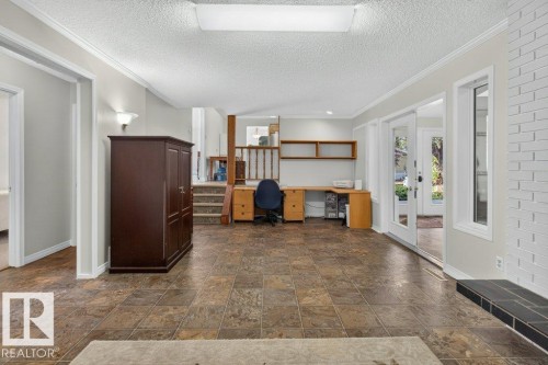 Tiled flooring, built-in shelving, white brick accent wall, and sliding glass doors - #74 22555 Twp Road 530, Rural Strathcona County, AB 