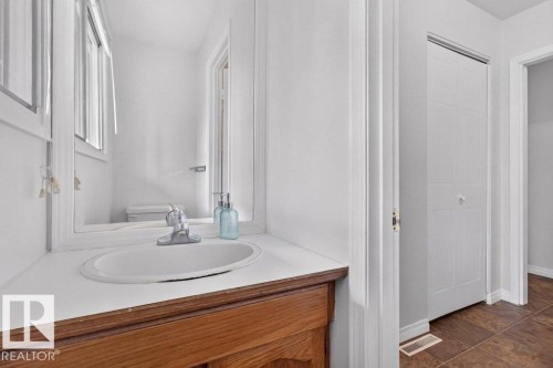 Wood-finish vanity with an oval sink and chrome faucet - #74 22555 Twp Road 530, Rural Strathcona County, AB 