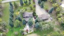 Expansive property featuring a multi-structure layout, mature tree landscaping, and a substantial driveway - #74 22555 Twp Road 530, Rural Strathcona County, AB 