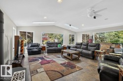 Vaulted ceiling with recessed lighting, skylights, and a ceiling fan - 