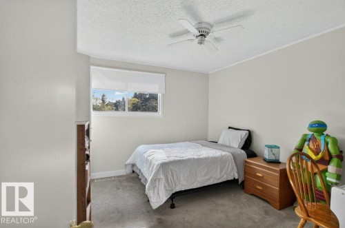 Recessed window with roller shade, ceiling fan, carpeted flooring, and neutral wall tones - #74 22555 Twp Road 530, Rural Strathcona County, AB 
