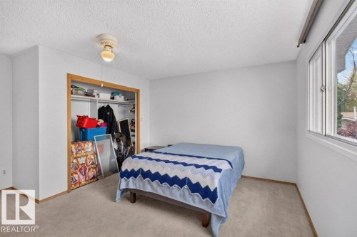 Recessed closet with natural wood-finish trim, neutral carpeting, and a single-pane window - #74 22555 Twp Road 530, Rural Strathcona County, AB 