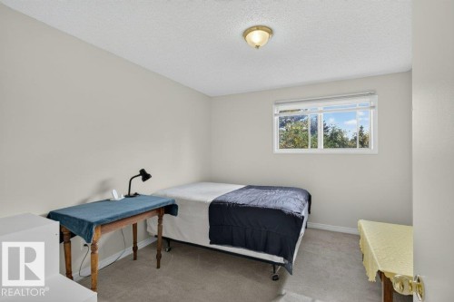Carpeted flooring, neutral wall color, window with white blinds, and a ceiling-mounted light fixture - #74 22555 Twp Road 530, Rural Strathcona County, AB 
