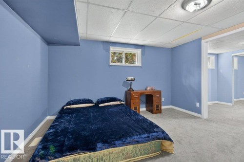 Carpeted flooring, drop ceiling, white trim, and a functional window - #74 22555 Twp Road 530, Rural Strathcona County, AB 
