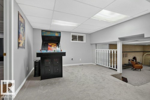 Recessed ceiling with integrated lighting, window for natural light, wall-to-wall carpeting, and a white spindle railing - #74 22555 Twp Road 530, Rural Strathcona County, AB 
