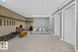 Brick accent wall with an arched alcove and fireplace - 