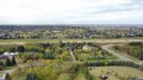 Expansive grounds featuring mature trees and a manicured lawn - #74 22555 Twp Road 530, Rural Strathcona County, AB 