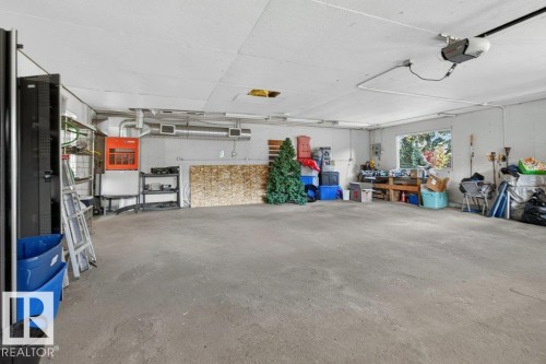 Spacious garage with exposed ductwork, a large window, and a concrete floor - #74 22555 Twp Road 530, Rural Strathcona County, AB 