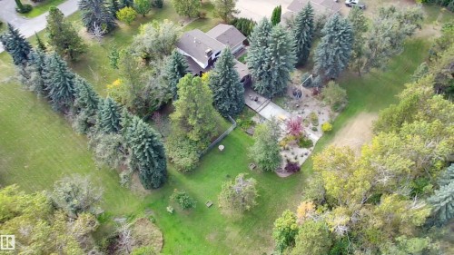 Expansive property featuring a mature treed perimeter, established landscaping, and a two-story residence with a multi-gabled roofline - #74 22555 Twp Road 530, Rural Strathcona County, AB 