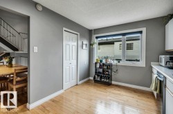 Hardwood flooring, painted interior walls, white window trim, white bi-fold door, and white ceiling - 
