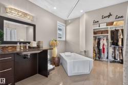 Freestanding soaking tub with a built-in organized closet system - 