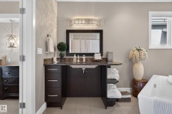 Modern vanity with a dark wood-finish cabinet, integrated sink, and stone-finish countertop - 