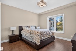 Recessed lighting and a decorative ceiling fixture illuminate the room - 