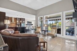 Vaulted ceilings, large windows, tiled flooring, built-in kitchen appliances, and a covered outdoor patio - 
