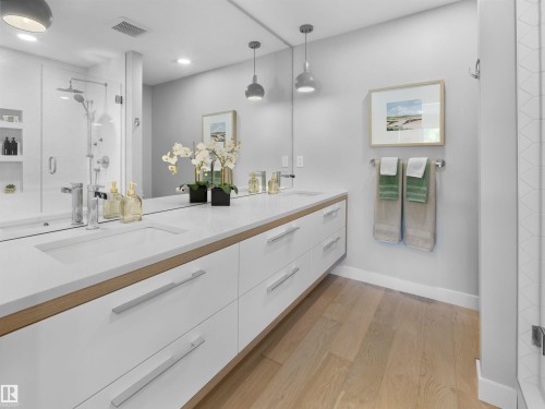 Extended floating vanity with dual integrated sinks, wood-finish accents, and white cabinetry - 9118 89 Street Nw, Edmonton, AB 