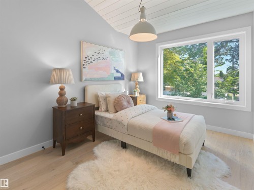 Vaulted ceiling with wood-paneled finish, light wood-finish flooring, and large window with white trim - 9118 89 Street Nw, Edmonton, AB 