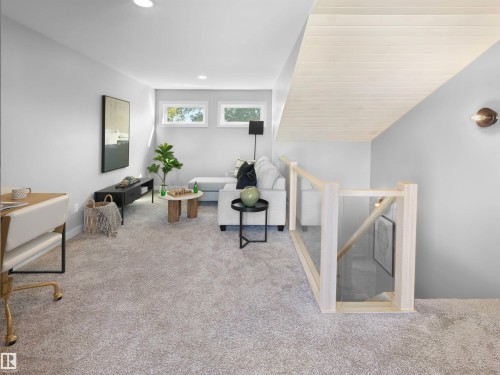 Recessed lighting, wood-finish stairwell ceiling, light-toned carpet, and multiple windows providing natural illumination - 9118 89 Street Nw, Edmonton, AB 